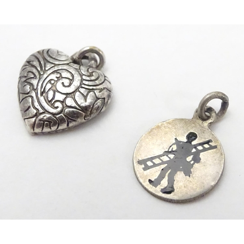 507 - Two pendant charms, one f heart form, the other circular with silhouette decoration. Each approx. 1/... 