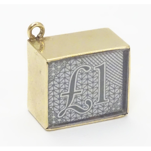 512 - A novelty 9ct gold pendant charm of squared form. Engraved ' In Emergency break glass' and containin... 