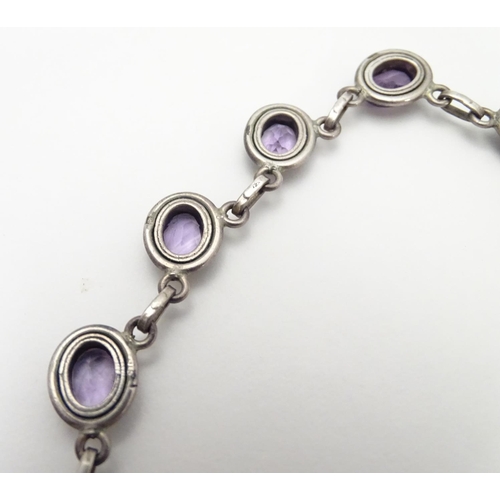 514 - A silver and amethyst suite of jewellery comprising necklace bracket and earrings