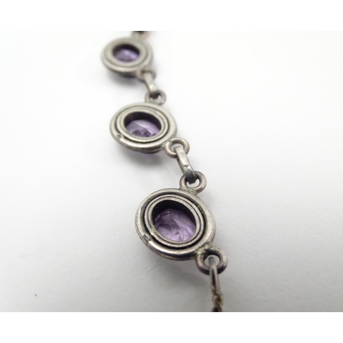 514 - A silver and amethyst suite of jewellery comprising necklace bracket and earrings