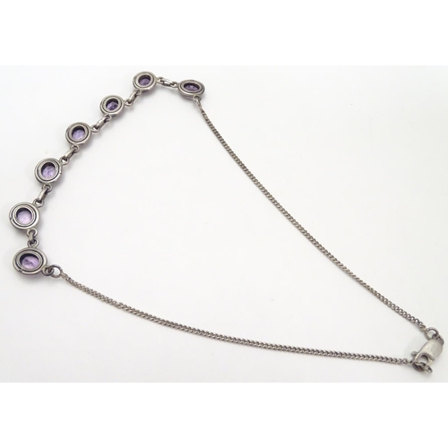 514 - A silver and amethyst suite of jewellery comprising necklace bracket and earrings