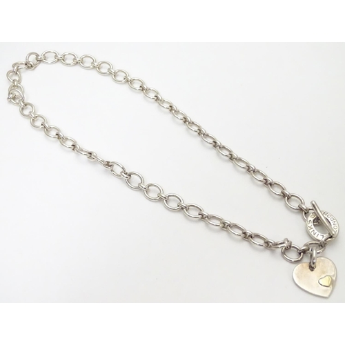 518 - A silver chain necklace by Links of London, with engraved / inscribed heart pendant. Approx 16