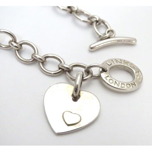 518 - A silver chain necklace by Links of London, with engraved / inscribed heart pendant. Approx 16