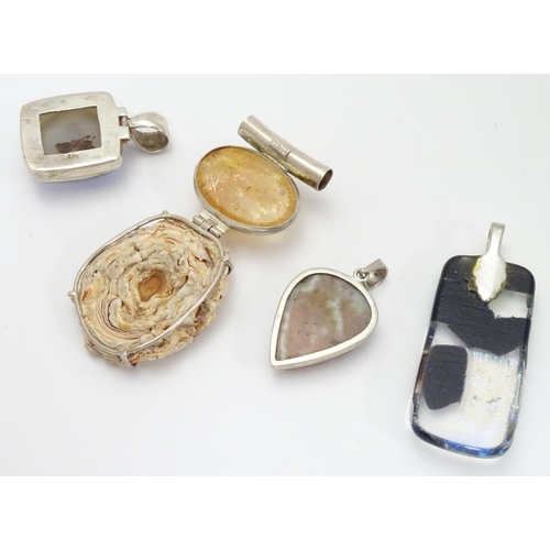 519 - Four various silver and white metal mounted pendants, including an Art Glass example 2 1/2