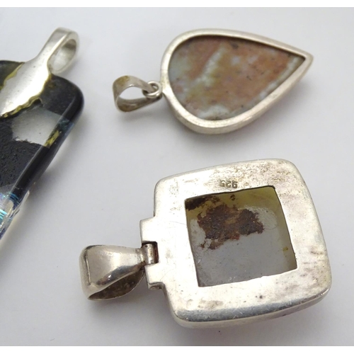 519 - Four various silver and white metal mounted pendants, including an Art Glass example 2 1/2