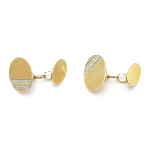 521 - A pair of 9ct gold cufflinks of oval form.