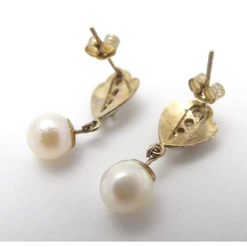 524 - A pair of yellow metal earrings set with white stones and pearl drops, together with three .925 silv... 