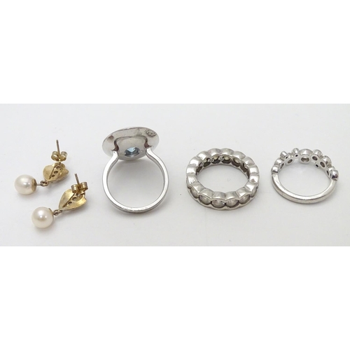 524 - A pair of yellow metal earrings set with white stones and pearl drops, together with three .925 silv... 