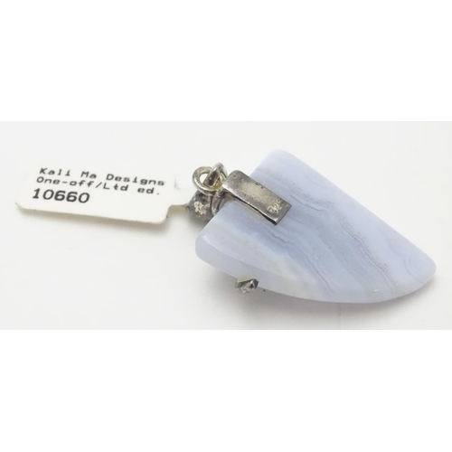 528 - A silver mounted hardstone set pendant, the polished Blue Lace Agate formed as a stylised shark’s to... 