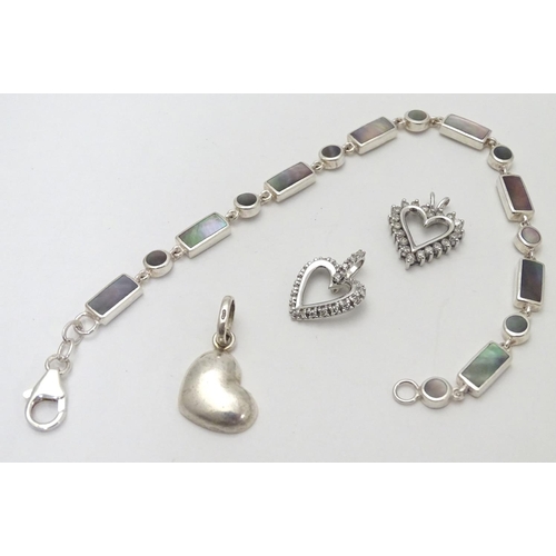 531 - A silver bracelet set with abalone shell detail  together with and 3 assorted charms (4)