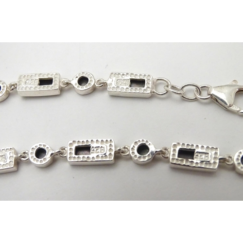 531 - A silver bracelet set with abalone shell detail  together with and 3 assorted charms (4)