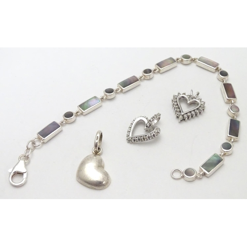 531 - A silver bracelet set with abalone shell detail  together with and 3 assorted charms (4)