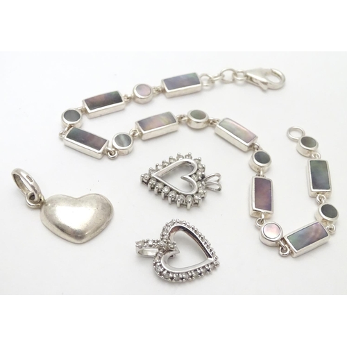 531 - A silver bracelet set with abalone shell detail  together with and 3 assorted charms (4)