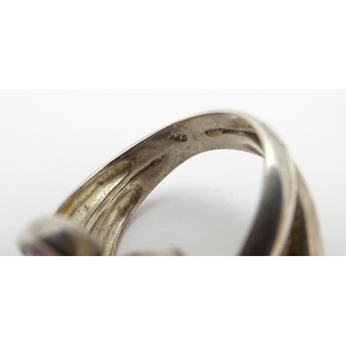 534 - A silver bracelet of bangle form Hallmarked Birmingham 1974 together with a silver dress ring set wi... 