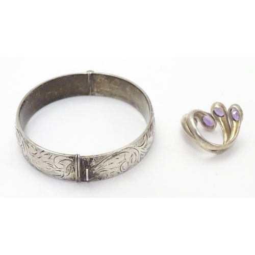 534 - A silver bracelet of bangle form Hallmarked Birmingham 1974 together with a silver dress ring set wi... 