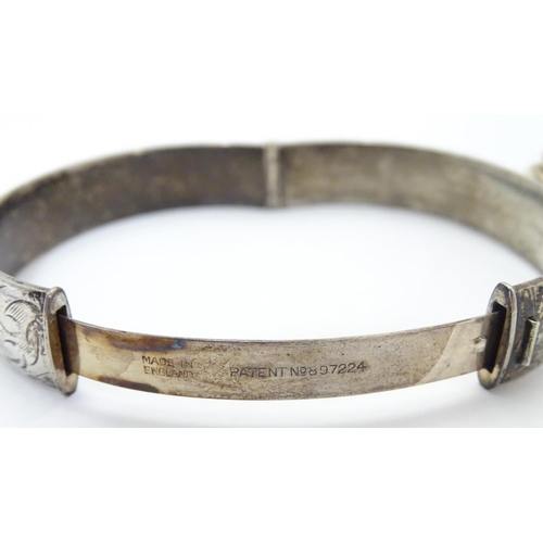 534 - A silver bracelet of bangle form Hallmarked Birmingham 1974 together with a silver dress ring set wi... 