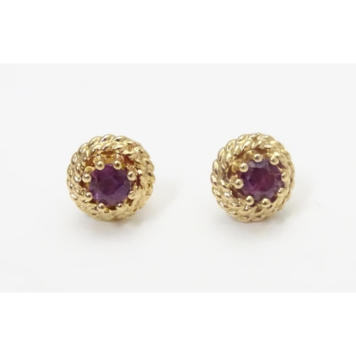 544 - A pair of 9ct stud earring set with red spinel 1/4