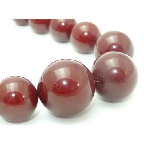 550 - A vintage necklace of graduated  cherry amber Bakelite beads. Approx 15