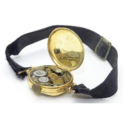 558 - An early 20thC Ladies' wrist watch , with fabric strap and 18ct gold case