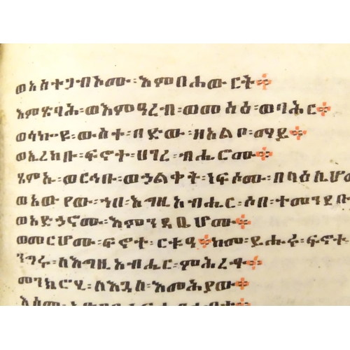 627 - Book: An Ethiopian handwritten coptic bible / prayer book / manuscript, the vellum pages with red an... 