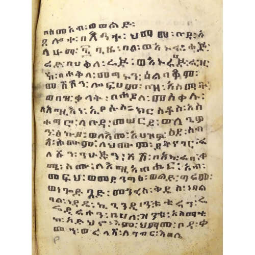 627 - Book: An Ethiopian handwritten coptic bible / prayer book / manuscript, the vellum pages with red an... 