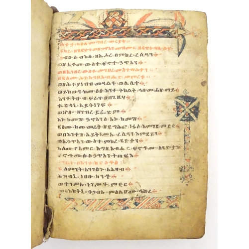 627 - Book: An Ethiopian handwritten coptic bible / prayer book / manuscript, the vellum pages with red an... 