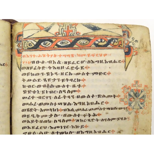 627 - Book: An Ethiopian handwritten coptic bible / prayer book / manuscript, the vellum pages with red an... 