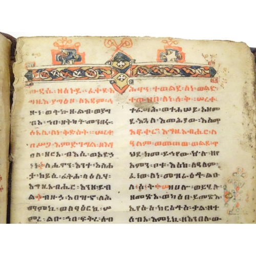 627 - Book: An Ethiopian handwritten coptic bible / prayer book / manuscript, the vellum pages with red an... 