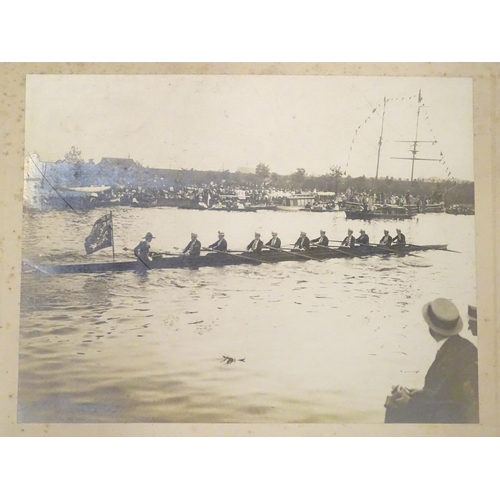 674 - An early 20thC monochrome photograph depicting a rowing Regatta, a passing racing boat with crew of ... 