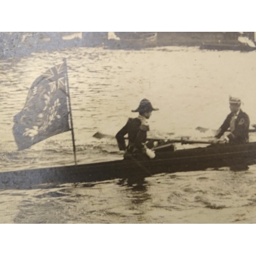 674 - An early 20thC monochrome photograph depicting a rowing Regatta, a passing racing boat with crew of ... 