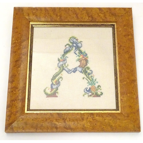 676 - A 20thC cross stitch embroidery / needlework depicting the alphabet letter A formed from stylised fl... 