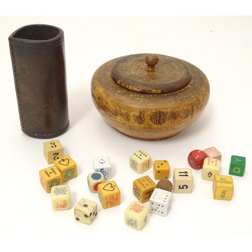 696 - Toys: A treen 19thC turned fruitwood pot and cover containing an assortment of dice, together with a... 