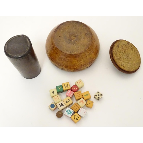 696 - Toys: A treen 19thC turned fruitwood pot and cover containing an assortment of dice, together with a... 