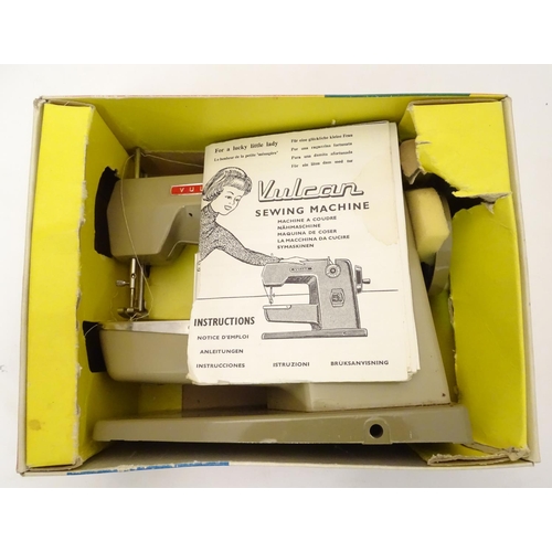 698 - Toy: A 20thC Vulcan Countess child's sewing machine, hand operated. With original box and instructio... 