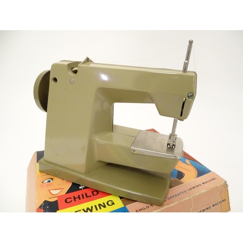 698 - Toy: A 20thC Vulcan Countess child's sewing machine, hand operated. With original box and instructio... 