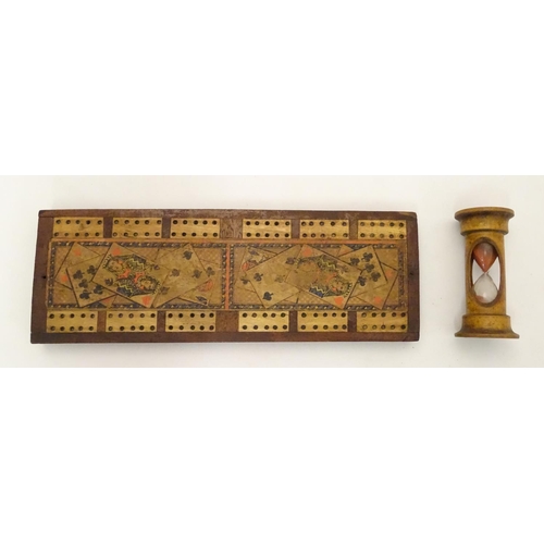 703 - Toys: A late 19th / early 20thC cribbage board with playing card decoration, together with a treen e... 