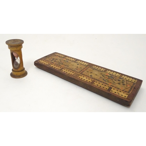 703 - Toys: A late 19th / early 20thC cribbage board with playing card decoration, together with a treen e... 