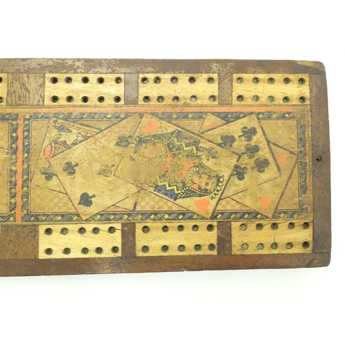 703 - Toys: A late 19th / early 20thC cribbage board with playing card decoration, together with a treen e... 