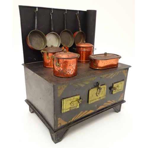 707 - Toy: An early 20thC French tin toy kitchen stove with chimney by Jouet de Paris. The front with thre... 