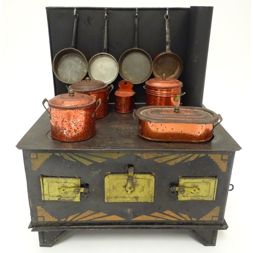 707 - Toy: An early 20thC French tin toy kitchen stove with chimney by Jouet de Paris. The front with thre... 