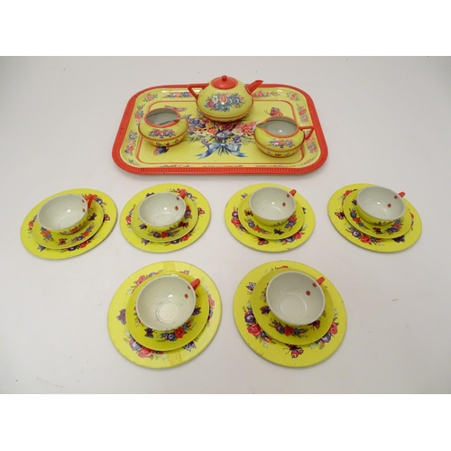 708 - Toys: A mid 20thC Chad Valley tinplate tea set in bright yellow decorated with sprays of flowers and... 