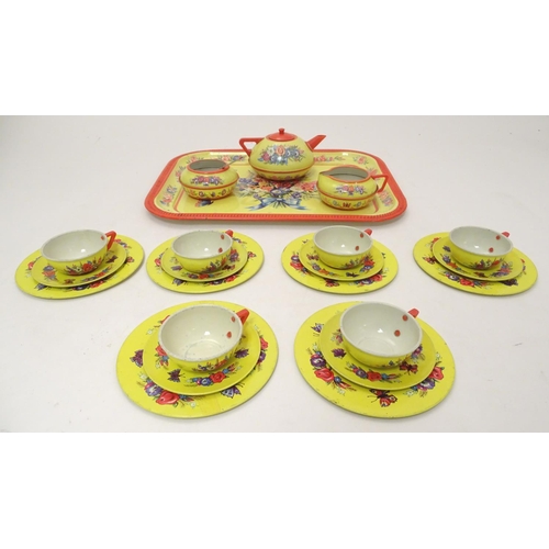 708 - Toys: A mid 20thC Chad Valley tinplate tea set in bright yellow decorated with sprays of flowers and... 