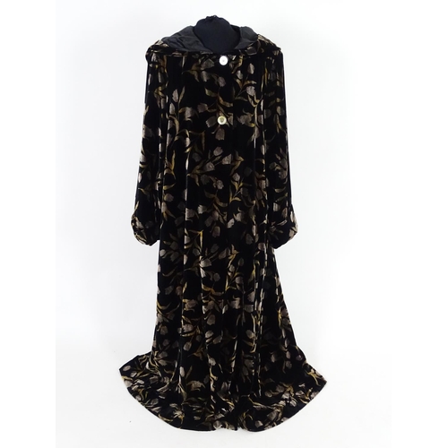 712 - A Vintage full length velvet coat with hood. Black with floral design. Hand made by 'Forget Me Not' ... 