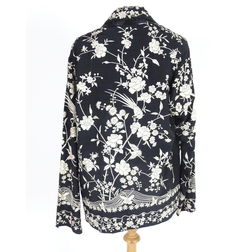 722 - An oriental silk black vintage jacket, embroidered with cream flowers, birds and butterflies. Bust s... 