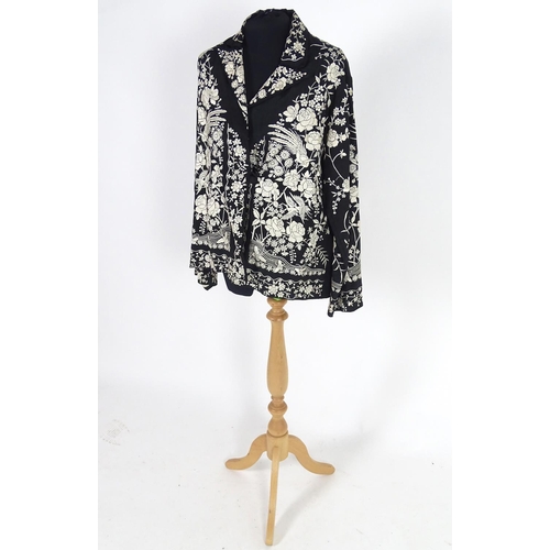 722 - An oriental silk black vintage jacket, embroidered with cream flowers, birds and butterflies. Bust s... 