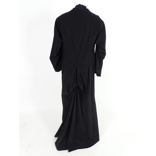 737 - A black full length clergymans' cassock. Chest size 40