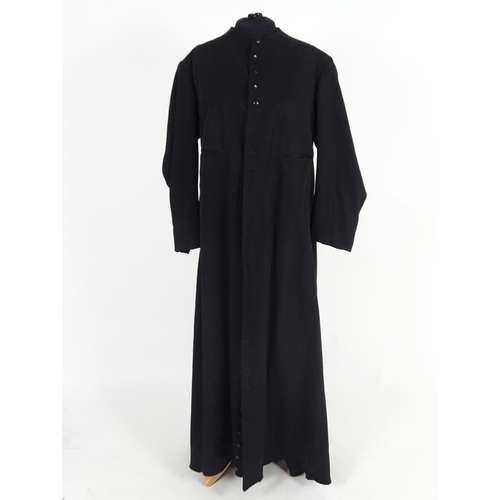 737 - A black full length clergymans' cassock. Chest size 40