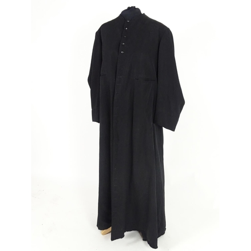 737 - A black full length clergymans' cassock. Chest size 40