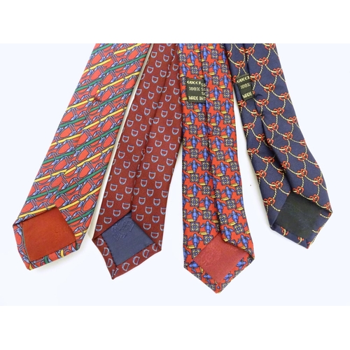 748 - 4 Gucci silk ties, in various designs of reds and blues (4)