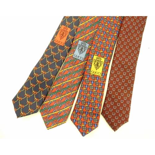 748 - 4 Gucci silk ties, in various designs of reds and blues (4)